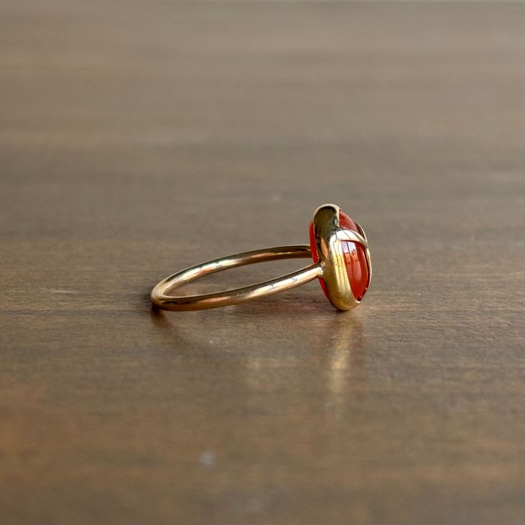 A little blaze of charm from a fiery scarab keeps luck close to hand in this dainty ring. 14k yellow gold Carnelian 8mm x 10mm (5/16" x 3/8") Classic Carnelian Rings With Polished Finish, Oval Carnelian Gemstone Signet Ring, Polished Carnelian Oval Rings, Oval 14k Gold Enamel Ring Gift, Oval 14k Gold Enamel Gift Ring, Yellow Gold Carnelian Signet Ring Gift, Gift Carnelian Yellow Gold Signet Ring, Yellow Gold Carnelian Signet Ring As A Gift, Gift Carnelian Signet Ring In Yellow Gold