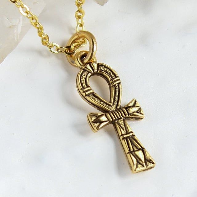 "Gold Ankh Necklace, Egyptian cross Jewelry, eternal life Symbol of Life Layering Necklace, Personalized Initial Charm, Mother's day gift Listing is for the solo Ankh charm necklace on a gold chain. You can personalize this necklace, by: ADDING initial charms here: https://etsy.me/2ZypsB3 ADDING Swarovski birthstones here: https://etsy.me/356yFBC Cross is 7/8\" long, it's a delicate small cross necklace. The Ankh cross was a very powerful Ancient Egyptian symbol for eternal life and good health. Spiritual Cross Pendant Necklaces For Gift, Spiritual Cross Pendant Necklace For Gift, Personalized Spiritual Cross Pendant Jewelry, Spiritual Crucifix Charm Necklace, Spiritual Pendant Cross Necklace, Spiritual Cross Necklace As Gift, Adjustable Engraved Cross Pendant Jewelry, Nickel-free Symbolic Crucifix Jewelry, Crucifix Charm Necklace As Gift