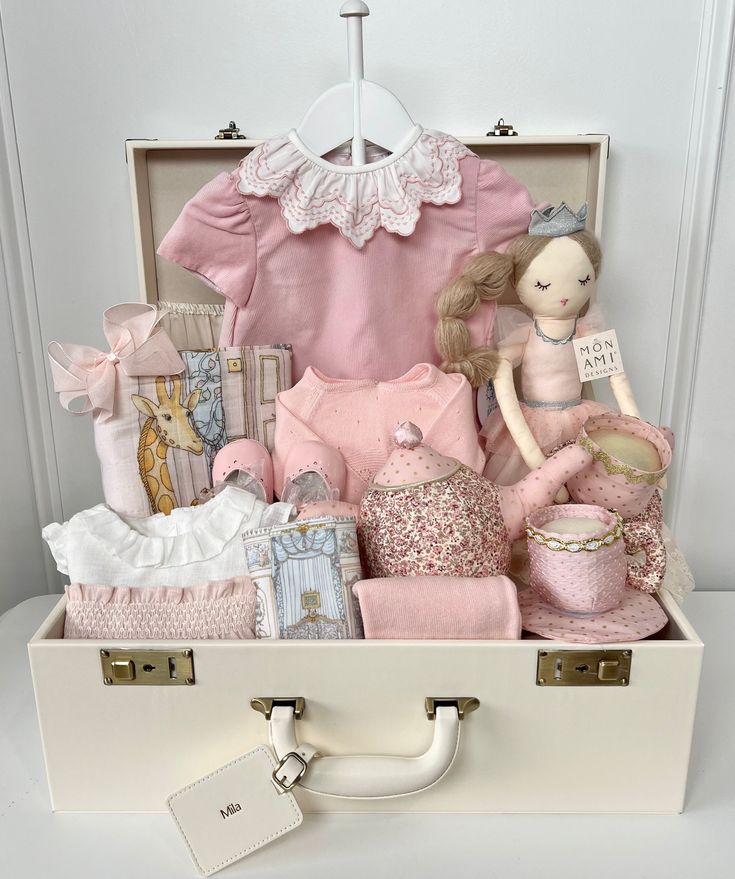 a white suitcase filled with baby items on top of a table