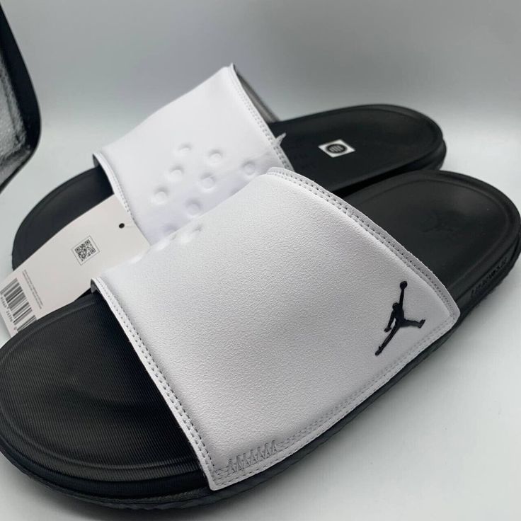 Air Jordan Play Slide White/Black Sandals Modern Black Slip-on Flip Flops, White Synthetic Sandals With Removable Insole, White Closed Toe Casual Flip Flops, Casual White Closed Toe Flip Flops, White Non-slip Casual Sport Sandals, Casual White Non-slip Sport Sandals, Modern Black Flip Flops With Textured Footbed, White Slides For Streetwear, White Synthetic Open Toe Sport Sandals