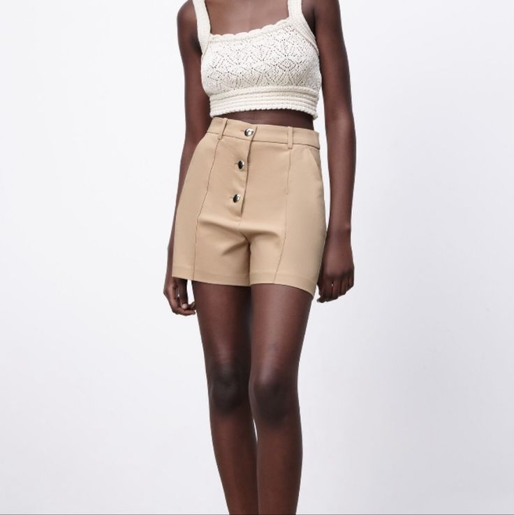 Front Pleats Side Pockets Gold Buttton Closure High Waist Beige Bottoms With Buttons, High-waist Beige Bottoms With Buttons, Trendy Beige Shorts For Workwear, Trendy Beige Workwear Shorts, High Waist Shorts With Buttons, Cream High-waisted Fitted Shorts, Cream Fitted High-waisted Shorts, High-waisted Cream Shorts For Work, High Waist Cream Shorts For Work