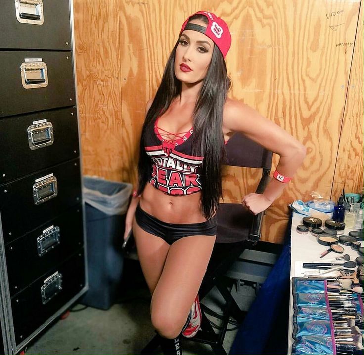 a beautiful young woman standing in front of a filing cabinet