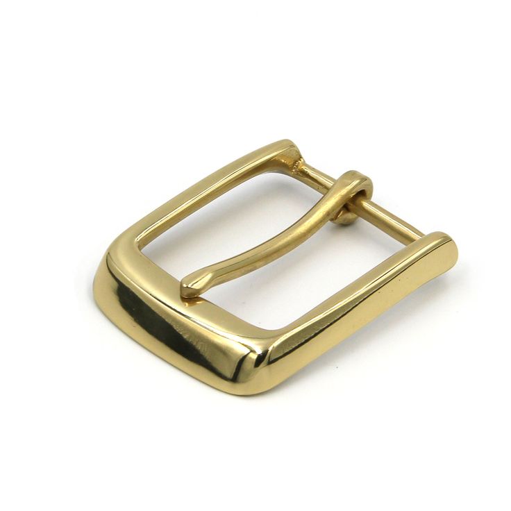 a gold buckle on a white background