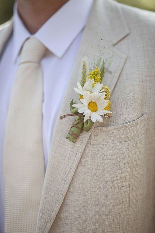 a man in a suit with a flower on his lapel