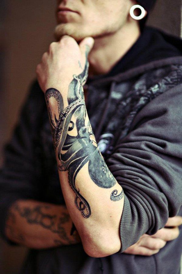 a man with tattoos on his arms and arm