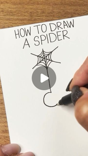 someone is drawing a spider on a piece of paper that says how to draw a spider