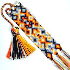 an orange, yellow and blue tie with tassels is shown on a white background