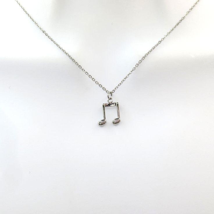 a musical note necklace on a mannequin