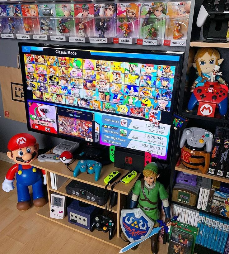 a nintendo wii game console with mario and luigi figurines on the shelf next to it