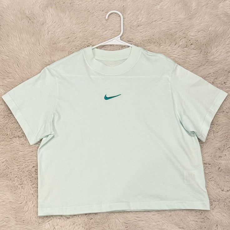 Girl’s Nike Sportswear Essentials Boxy Tee; Mint Foam; Size L; Never Worn; 100% Cotton; Excellent Condition Trendy Nike Sports Tops, Light Blue Athleisure Top For Streetwear, Light Blue Crew Neck Sports Top, Sporty Light Blue Tops For Streetwear, Light Blue Crew Neck Sport Top, Light Blue Cotton Sports Top, Sporty Light Blue Cotton Top, Blue Letter Print Sportswear Tops, Sporty Light Blue Nike Tops