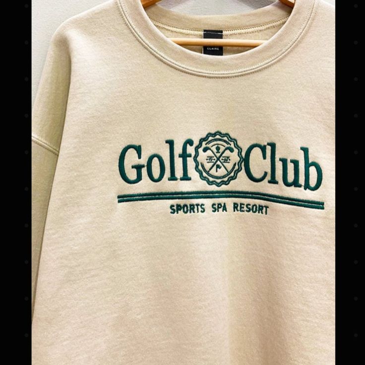 This Embroidered Golf Club Sweatshirt Features A Classic And Oversized Design, Providing Both Style And Comfort On The Course. Made For All Golf Lovers Of All, The Sweatshirt Allows For Unrestricted Movement And Keeps You Warm On Those Chillier Days. Stand Out On The Green With This Timeless Piece. 50% Cotton 50% Polyester Photos Have Been Edited To Enhance Color Warm Taupe, Club Sweatshirts, Flannel Tops, Graphic Tops, Loungewear Sets, Embroidered Sweatshirts, Oversized Sweatshirt, Embroidered Design, Golf Club