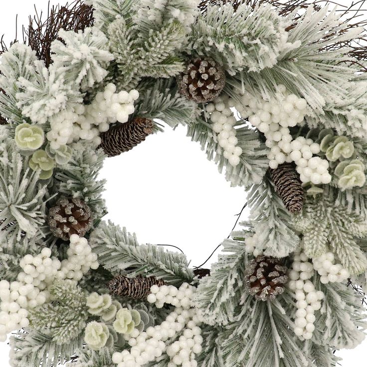 a wreath with pine cones and white flowers