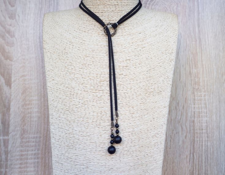 "Long Cord Necklace Lariat Tie Choker Choker Onyx Necklace Suede Wrap Necklace Long Tie Necklace Vegan Choker Black Suede Necklace ~ Long Wrap Necklace with cord and onyx beads. - Made of metal and black colour suede cord, ~ Made with the utmost care to enjoy it as long as possible. All jewelries are are in stock and ready to be shipped within 1-2 business day from ordering to dispatch. Please note these times increase during Christmas & busy periods. 🌍 SHIPPING & DELIVERY This necklace is read Elegant Black Beads Lariat Jewelry, Adjustable Dangle Lariat Necklace For Party, Elegant Black Beaded Lariat Jewelry, Elegant Lariat Choker With Adjustable Length, Lariat Choker With Clavicle Chain, Adjustable Lariat Long Necklace For Party, Lariat Clavicle Chain Choker, Elegant Black Lariat Beaded Necklace, Clavicle Chain Lariat Choker