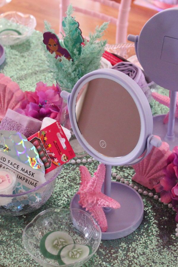 a table topped with lots of pink and purple items