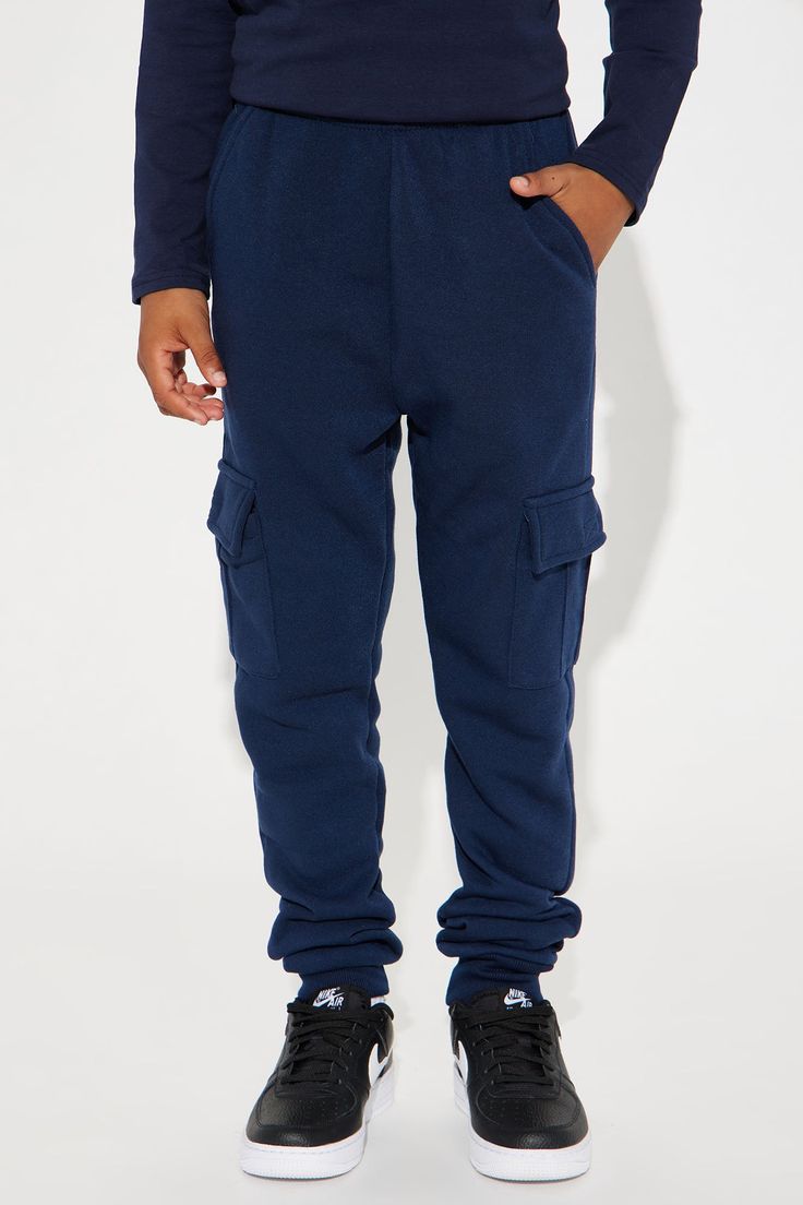 Available In Navy, Black, Heather Grey, Charcoal, Camel, And Olive. Joggers Side Pockets Solid Cargo Elastic Waist Model Wears Size 10 100% Polyester Imported | Mini Fly Vibes Jogger Pant in Navy Blue size 4 by Fashion Nova Blue Full Length Sweatpants With Pockets, Blue Winter Bottoms With Pockets, Winter Blue Bottoms With Pockets, Casual Blue Pants With Ribbed Waistband, Navy Bottoms With Pockets For Winter, Winter Navy Bottoms With Pockets, Casual Navy Bottoms With Hip Pockets, Navy Casual Cargo Pants With Pockets, Casual Navy Cargo Pants With Pockets