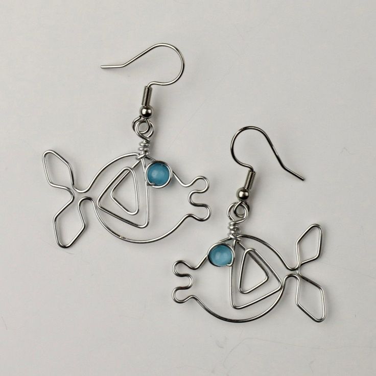 Fish earrings are made with turquoise blue beads for eyes.  Aluminum wire will not tarnish. Lightweight. Surgical steel posts are hypo-allergenic. Clear plastic stopper on back. PLEASE NOTE ALL ITEMS IN MY ETSY SHOP ARE COPYRIGHT PROTECTED AND MAY NOT BE REPRODUCED WITHOUT PERMISSION. Wire Fish, Fish Earrings, Earrings Dangling, One Fish, For Eyes, Youtube Tutorials, Turquoise Beads, Blue Beads, Clear Plastic