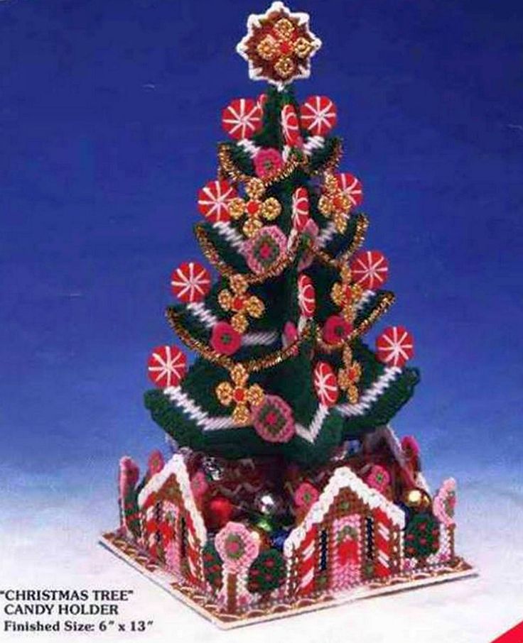 a christmas tree made out of gingerbreads and candy canes on a stand