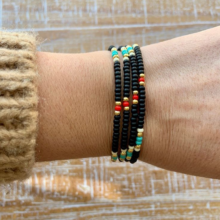 "Black, turquoise, red, white and gold beaded wrap style bracelet is 28\" long and will wrap around on average wrist (6.5-7\") four times. It comes with 1\" chain extender. It could be worn also as a necklace. Details: - Adjustable wrap style bracelet: 28\" long with 1\" chain extender, full length 29\" designed to fit 6.5-7\" wrists, - Listings include one bracelet - Bracelets may vary in exact pattern. Slight variations due to the individuality of each piece - This item should be kept away fro Black Heishi Beads Bracelet With Colorful Beads, Hand Wrapped Black Beaded Bracelets For Beach, Hand Wrapped Black Beach Jewelry, Hand Wrapped Black Jewelry For Beach, Spiritual Black Beaded Jewelry For Beach, Spiritual Black Beads Jewelry For Beach, Black Bohemian Beaded Bracelet With Colorful Beads, Black Heishi Beads Bracelet As Gift, Festival Hand-wrapped Black Beaded Bracelets