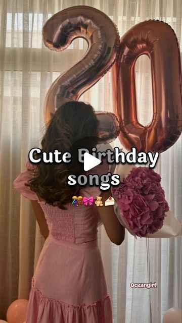 a woman in a pink dress holding a large number 20 balloon with the words cute birthday songs on it