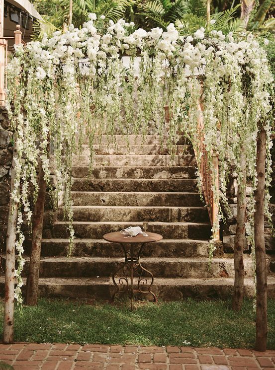 an outdoor area with stairs and flowers on the top, in black and white photo