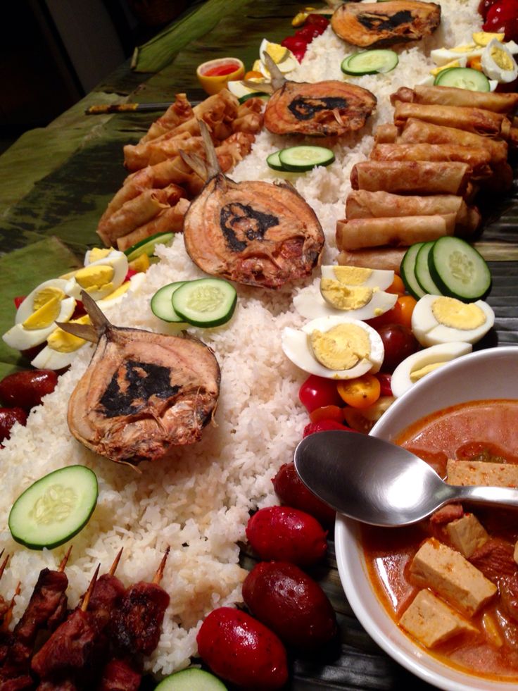 a table topped with lots of different types of food and bowls filled with sauces