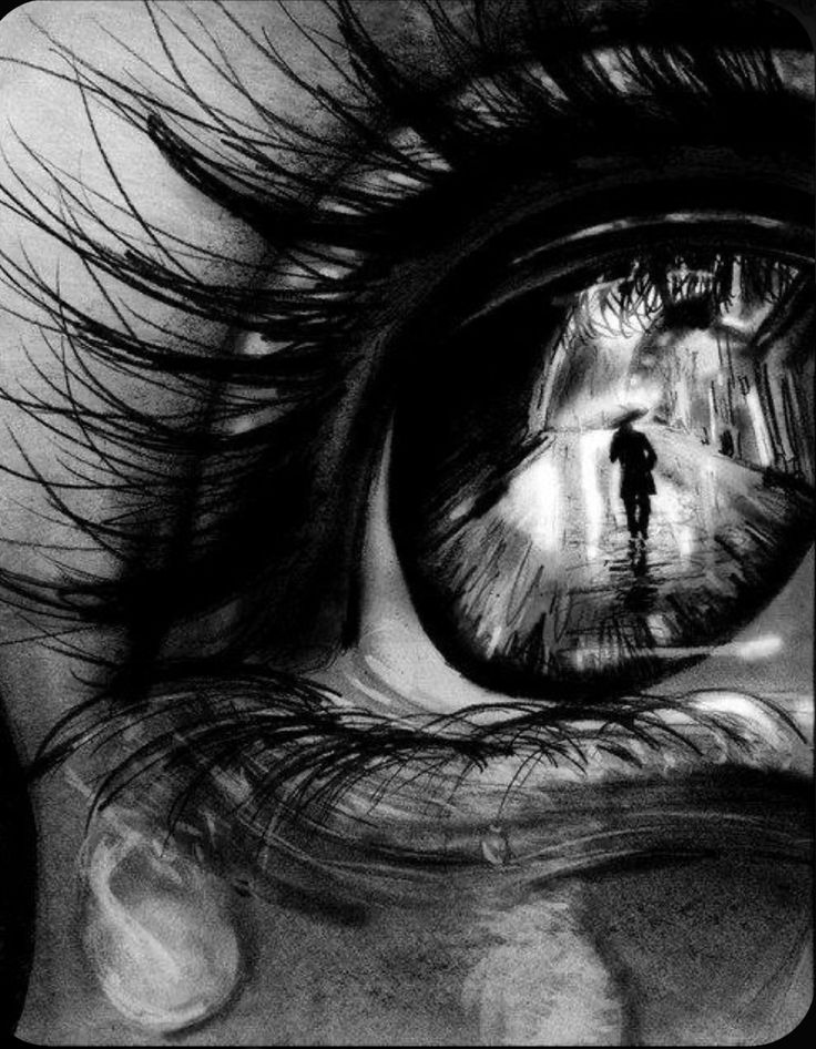 an eye with the reflection of a person standing in front of it and looking into the distance