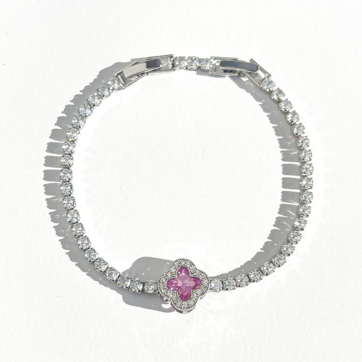 Elevate your wrist game with our stunning Diamond Clover Tennis Bracelet. Each CZ diamond sparkles with brilliance, creating a dazzling effect that catches every eye. The addition of the lucky clover charm brings a touch of whimsy and positivity to your style. Perfect for adding a dash of glamour to both casual and formal looks. Shine bright with this unique and charming accessory. Silver plated Water/tarnish resistant 7-8in adjustable Crystal Diamond Bracelet With Sparkling Stones As Gift, Crystal Diamond Bracelet As A Gift, Crystal Diamond Bracelet For Gifts, Crystal Diamond Bracelet Gift In Fine Jewelry Style, Gift Crystal Bracelet In Diamond White Cubic Zirconia, Diamond Crystal Bracelet With Sparkling Stones As Gift, Crystal Diamond Bracelet As Gift, Sparkling Diamond Crystal Bracelet As Gift, Sparkling Diamond Crystal Bracelet Gift