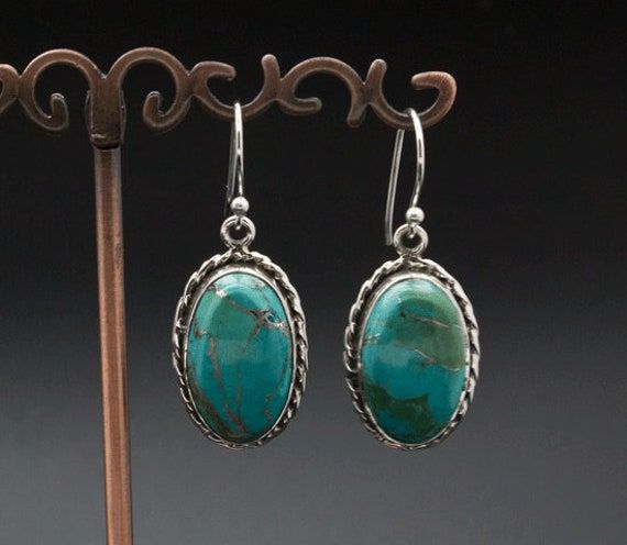 * Sterling Silver Turquoise Earrings. * These measure approximately 24mm x 15mm. * These are standard 20g earrings. * You will receive the exact pair pictured. Turquoise Sterling Silver Earrings With Silver Beads, Handmade Oval Turquoise Earrings, Turquoise Sterling Silver Chandelier Earrings, Hypoallergenic Turquoise Oval Earrings, Turquoise Sterling Silver Earrings - Fine Jewelry, Spiritual Turquoise Sterling Silver Earrings, Nickel-free Oval Turquoise Earrings, Nickel-free Turquoise Beaded Earrings In Sterling Silver, Sterling Silver Turquoise Earrings