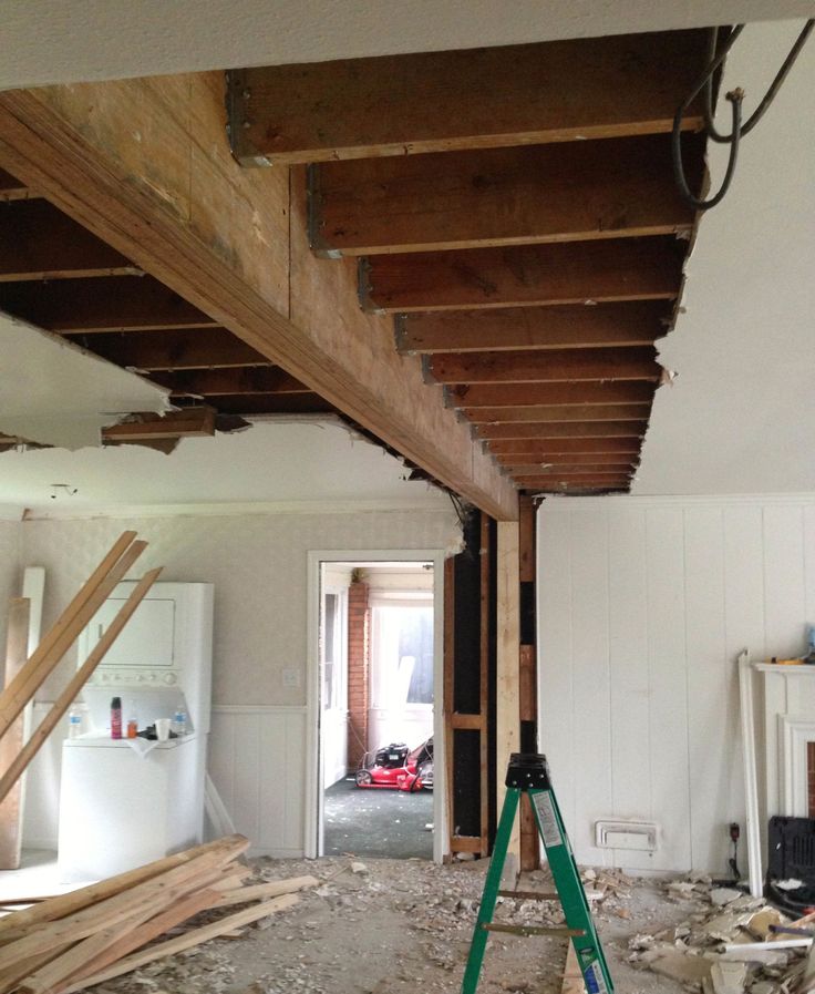 a room that is being remodeled with wooden beams