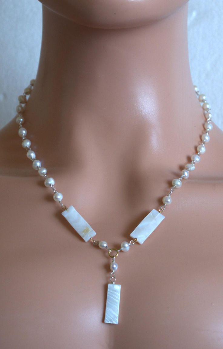 The necklace is made of 6mm freshwater pearl beads and adorn 23mm length mother-of-pearl connectors. A length is 16.5'' - 19.5'' (41.25cm - 48.75cm).  The necklace is ready to ship. Thank you for visiting my chop. Elegant Shell Necklace With Pearl Pendant, Elegant Pearl Pendant Shell Necklace, Elegant Wedding Shell Necklace With Pearl Charm, Elegant Shell Necklace With Baroque Pearl Drop, Elegant Gold Shell Necklace With Round Beads, Elegant Pendant Shell Necklace, White Gemstone Bead Necklaces For Weddings, Elegant Beaded Shell Necklace With Mother Of Pearl, Wedding Necklaces With Pearl Charm In Mother Of Pearl