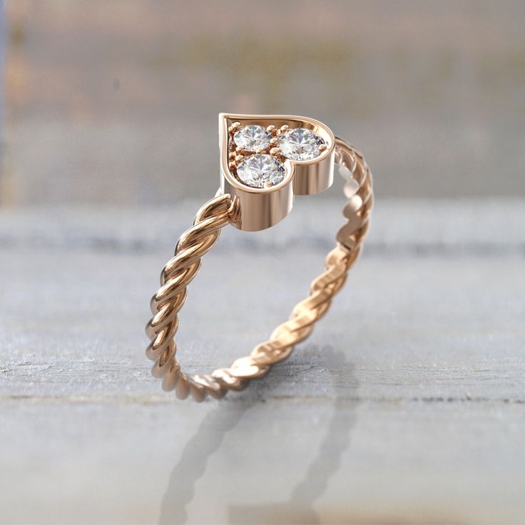 a gold ring with two diamonds on it