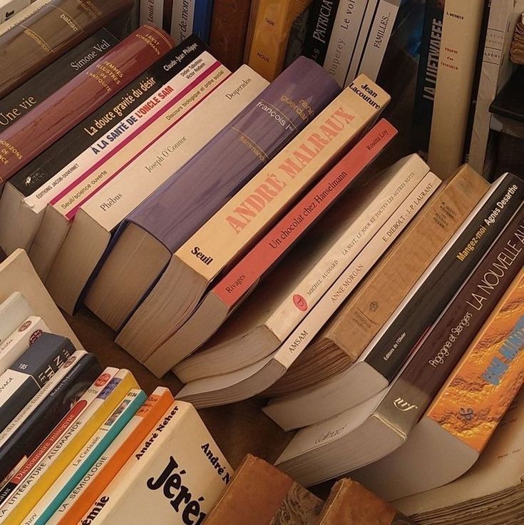 many books are stacked on top of each other