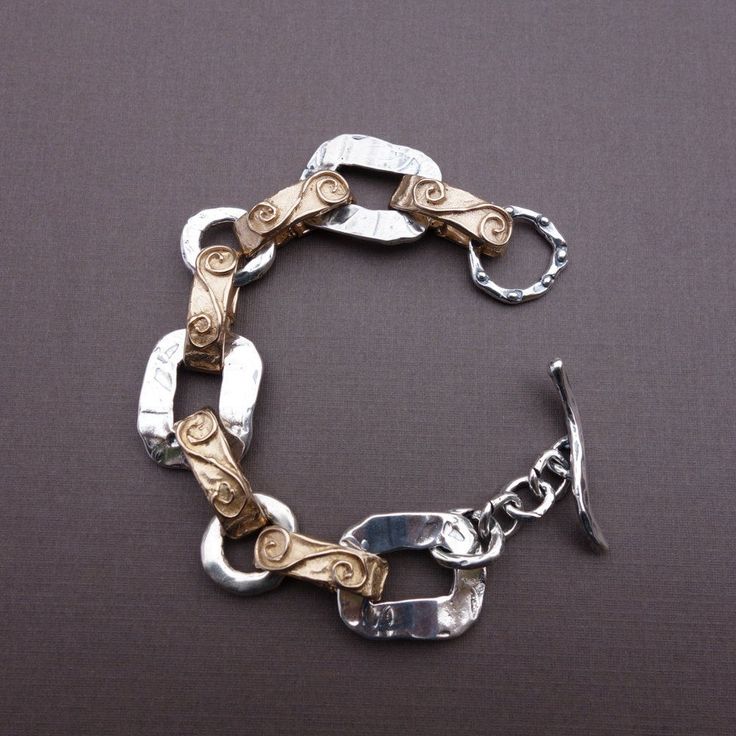 This handsome bracelet is new to my collection. I like the mix of silver and gold bronze: I am able to bring my price down and I just think it has a classy look! I make all my pieces in wax and then mold them. They are cast for me and then I put them together in my Bernalillo studio. As it is, this bracelet is seven inches long, but it could be sized up easily. I think it would work well for either a lady or a gentleman. Luxury Bracelet With Sterling Silver Clasp, Elegant Silver Mixed Metal Jewelry, Luxury Silver Brass Cuff Bracelet, Elegant Nickel-free Brass Chain Bracelet, Modern Gold Bracelets With Sterling Silver Clasp, Gold Bracelet With Sterling Silver Clasp For Everyday, Gold Bracelets With Sterling Silver Clasp For Everyday, Silver Hand-cast Metal Bracelets, Silver Brass Bracelets Hand Cast