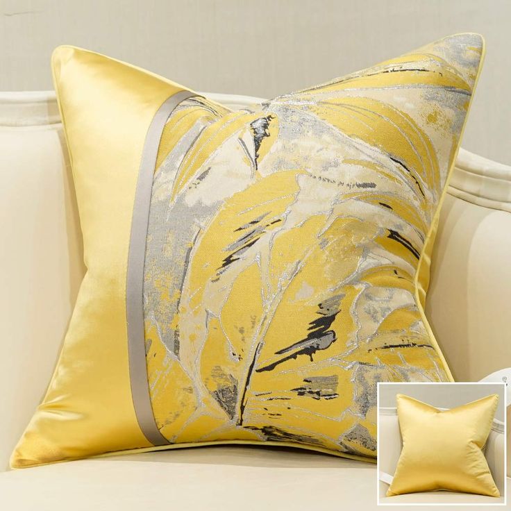 a white couch with a yellow and gray pillow on it's side, next to a photo of the cushion