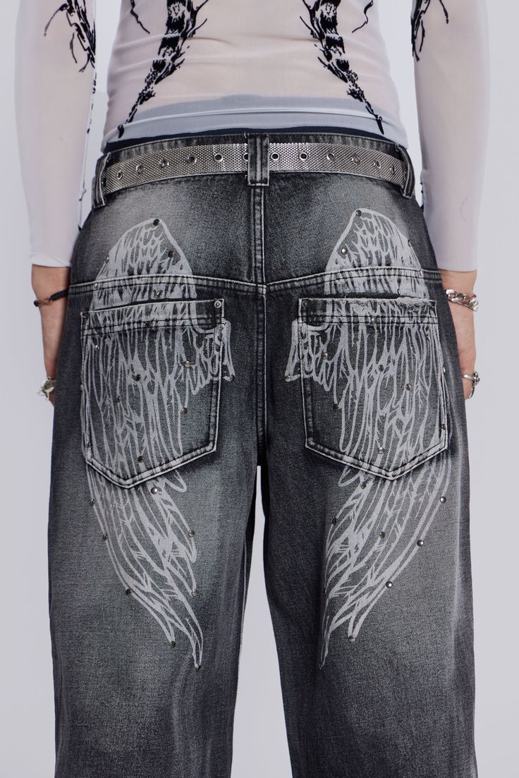 Black Ethereal Colossus Jeans Original low rise Colossus fit Heavy weight non-stretch denim x5 pocket styling Inside knee darts Heavy acid wash Wing screen print on back Stud detail to back print Model is 6 ft 1 and wears a size W32Style code: JMJE419485% Cotton, 10% Viscose, 5% PolyesterHand wash separatelyWash inside outLay flat to dryAvoid contact with light colours and upholstery as colour may transfer Gruge Jeans, Black Painted Jeans, Bleach Paint Jeans, Words On Jeans, Jeans Pocket Painting, Bleach Jeans Design, Pants Design Ideas, Bleached Trousers, Black Bleached Jeans