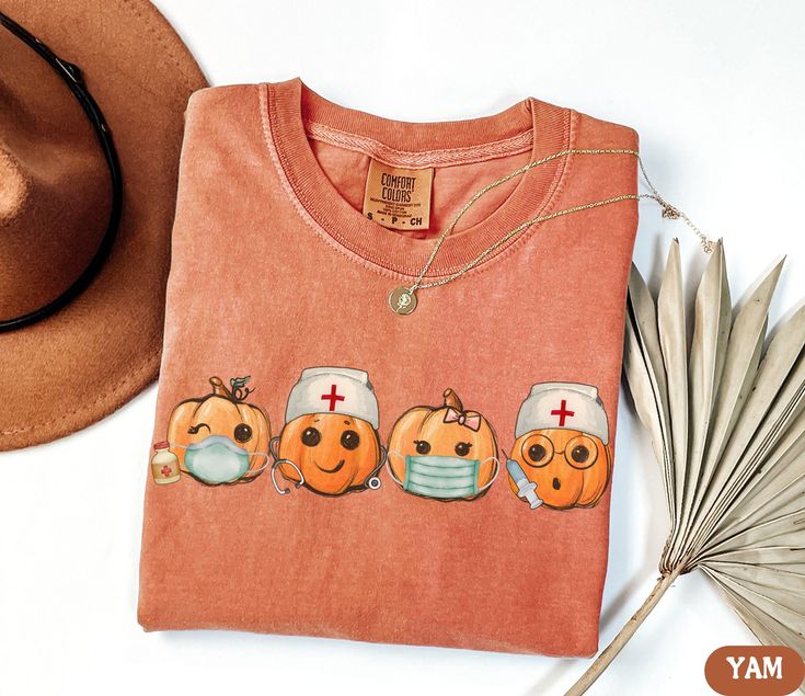 an orange tshirt with three doctors on it next to a hat and palm frisbee