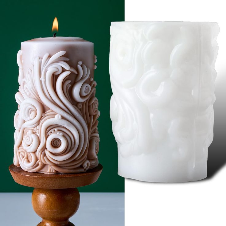 a white candle sitting on top of a wooden stand next to a ceramic vase with swirls