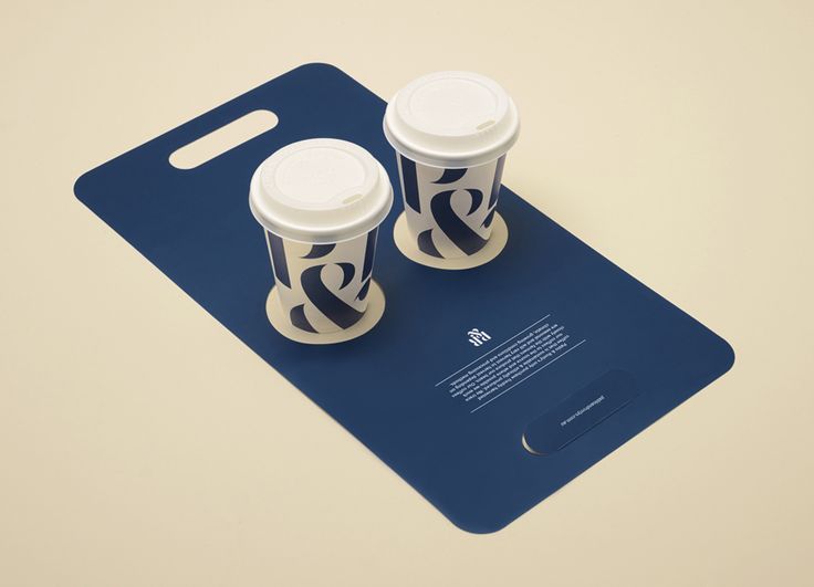 two coffee cups sitting on top of a blue tray