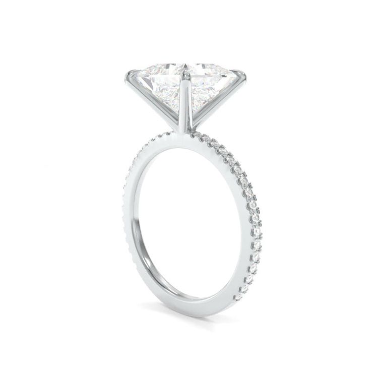 *Note that a gallery rail will need to be added on stone sizes 8.5mm and above Design DetailsThe Tara Ring is crafted with your selection of a moissanite or a lab grown diamond center stone and features round lab grown diamond accents. This ring is available in your choice of 18k gold or platinum. Browse #TheTaraRing hashtag on Instagram for additional photo and video footage. SpecificationsRender depicting an 8mm Princess TrueGem Moissanite. TrueGem Moissanite (D-F color, VVS1-VS1 clarity) or Radiant Cut Diamond Ring With Vvs Clarity, Radiant Cut Moissanite Wedding Ring In White Gold, Vvs Clarity Radiant Cut Diamond Ring, Refined Diamond Ring With Center Stone As Gift, Silver Radiant Cut Diamond Wedding Ring, Refined Diamond Jewelry With Center Stone, Diamond Solitaire Halo Ring, Moissanite Diamond Ring With Prong Setting, Diamond White Radiant Cut Diamond Ring With Vvs Clarity