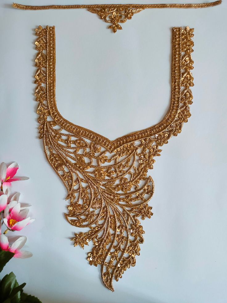 Introducing our exquisite Golden Embroidered Applique Sew-On Neckline Patch with Sleeves, showcasing intricate handcrafted Indian brass artwork that will elevate your garments to a whole new level of elegance and charm. This meticulously crafted patch is perfect for DIY enthusiasts looking to add a touch of Indian-inspired beauty to their dresses, saris, suits, and lehengas. ➤➤This set contains a Neckline and 2 sleeve patch- Crafted from high-quality materials, this applique patch guarantees dur Semi-stitched Gold Dress With Floral Embroidery, Traditional Gold Embroidered Dress With Resham Embroidery, Elegant Gold Dress With Resham Embroidery, Traditional Gold Embroidered Dresses, Gold Semi-stitched Dress With Floral Embroidery, Gold Embroidered Fabric For Festive Occasions, Gold Festive Embroidered Fabric, Gold Lace Work Dress For Festive Occasions, Festive Gold Dress With Lace Work