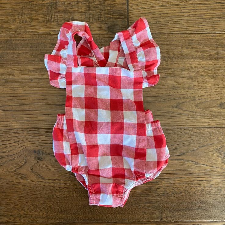 Excellent Condition. Never Used/Worn Checked Romper! Criss Cross Back And Bow Ruffle Straps Plaid Cotton Bubble Romper For Summer, Summer Plaid Cotton Bubble Romper, Summer Cotton Plaid Bubble Romper, Red Bubble Romper For Summer Playwear, Summer Red Bubble Romper For Playwear, Cute Red Bubble Romper For Playwear, Casual Red Summer Onesie, Cute Summer Plaid Bubble Romper, Cute Red Bubble Romper For Playtime