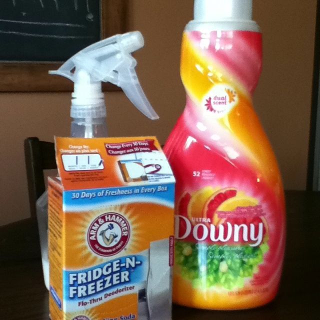 a bottle of downy and a carton of detergent sitting on a table