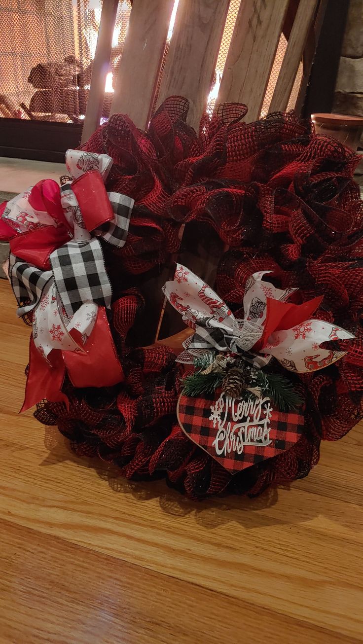 a christmas wreath on top of a wooden floor