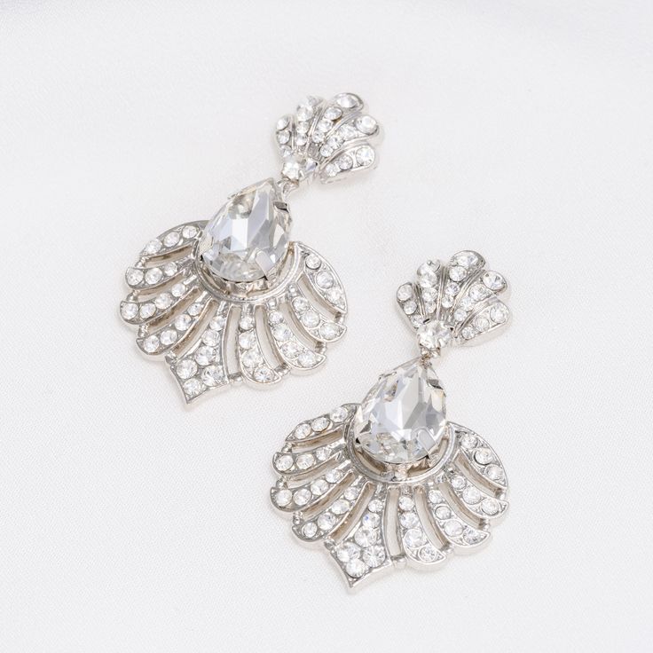 Stylish, enduring, and undeniably refined, the AKAY Swarovski Earrings bring a touch of whimsy and glamour to any look. Featuring bold clusters of shimmering crystals and an elegant scalloped design, these earrings catch the light beautifully with every move you make. Whether you're attending a special occasion or simply elevating your everyday style, the AKAY Earrings add the perfect finishing touch—timeless, bold, and unforgettable. Let your style shine effortlessly, no matter the moment. Hand