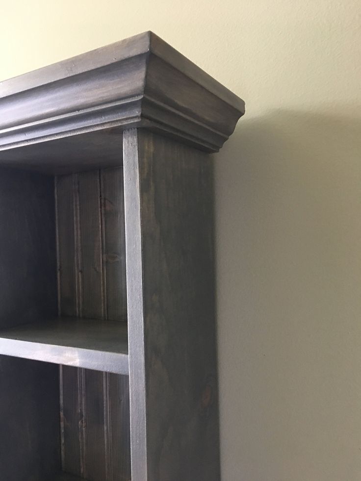 an empty book shelf in the corner of a room