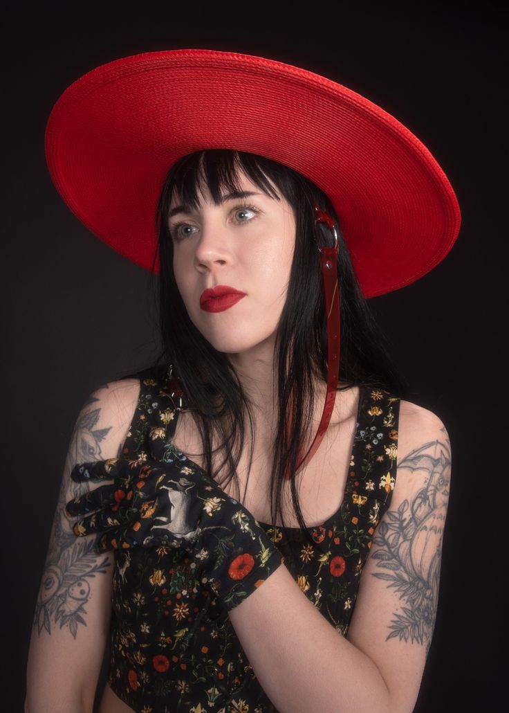 This red full-size faux straw hat is trimmed with a translucent red PVC buckle hat band and harness straps that buckle under the chin. Nice and structured, not floppy, with a wide brim and a round crown. The ultra-oversized brim paired with the bright red color makes this a dramatic statement piece! Fits up to a 23" head size. Shipped with a hat box. Material: 100% Polypropylene Crown Width: 6.5 inch Crown Height: 3.25 inch Brim Width: 5 inch This item is OVERSIZED so unfortunately shipping will Red Top Hat With Curved Brim For Spring, Red Brimmed Sun Hat For Party, Red Curved Brim Top Hat For Spring, Red Short Brim Sun Hat For Party, Red Short Brim Top Hat For Summer, Red Summer Boater Hat With Short Brim, Adjustable Red Hat Bands For Kentucky Derby, Fitted Red Straw Hat For Summer, Red Western Fedora For Kentucky Derby