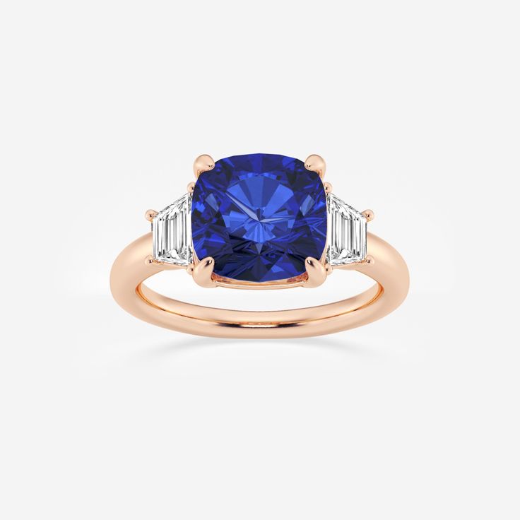 a blue sapphire and diamond ring with two baguets on the shoulders, set in 18k rose gold