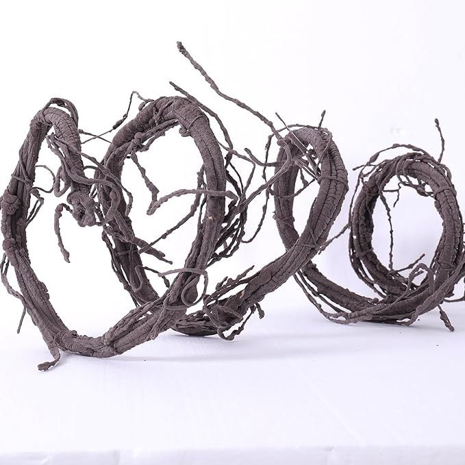 a bunch of branches that have been tangled together on a white tablecloth with the word love spelled in it