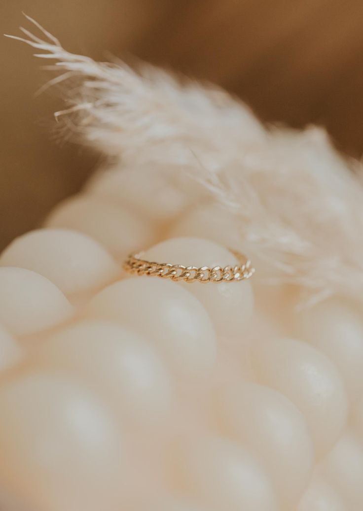 We love this chain ring worn individually for a simple adornment, or stacked for a stronger statement. 1.8mm band width. Available in 14kt Gold Fill. Due to the making process, this ring may run +/- 1/4 size. Paired on Jess with our Confetti Rings and Valley Trio. Handmade in Eau Claire, WI. Our jewelry is handmade so each piece will be unique and may vary slightly from what is pictured.