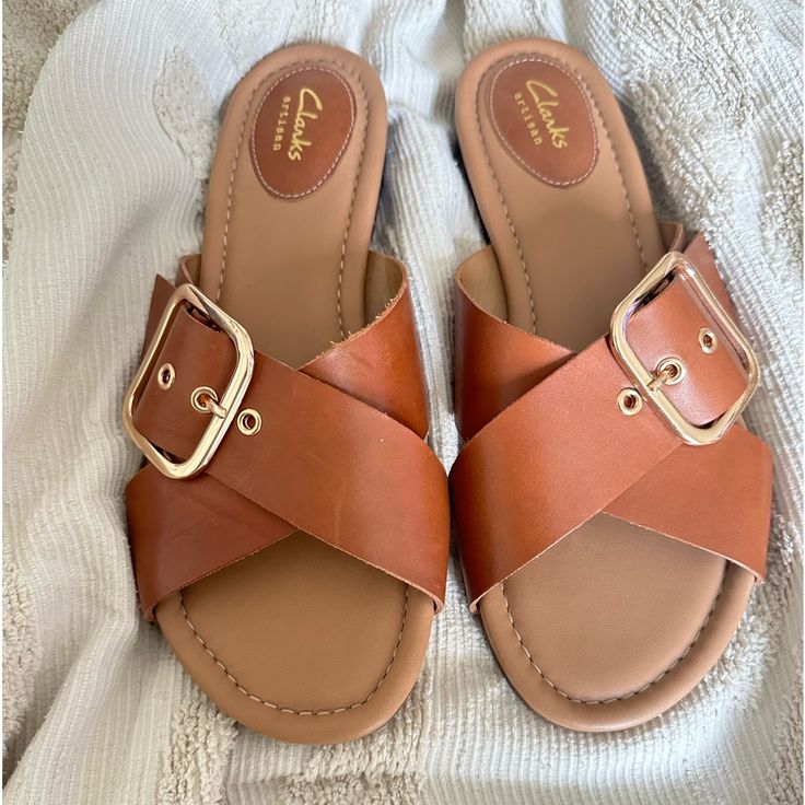 Clark’s Camel Leather New Never Worn Comfortable And Classy Size 9 Vacation Summer Classic Gold Buckle Leather Summer Vacation Brunch Leather Mules With Round Toe For Day Out, Leather Round Toe Mules For Day Out, Leather Slip-on Mules For Day Out, Beach Sandals With Buckle Closure In Faux Leather, Leather Sandals With Buckle Closure For Day Out, Leather Slide Sandals For Day Out, Brown Mules With Buckle Closure For Vacation, Brown Sandals With Buckle Closure For Day Out, Chic Brown Slide Sandals